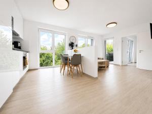 a kitchen and dining room with a table and chairs at TO-HAD, Modern Apartments next to U-bahn with free Wifi in Vienna