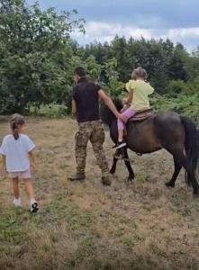 a man and a child riding a horse with a girl at Gioia Casa in Pizzo +3 photos