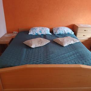 a bed with two pillows on top of it at Soba za vise osoba in Ilijaš