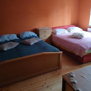 a bedroom with two beds and a dresser at Soba za vise osoba in Ilijaš
