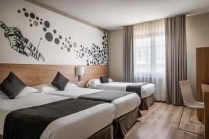 ein Hotelzimmer mit zwei Betten und einem Fenster in der Unterkunft Estival Sporting in Pas de la Casa