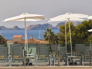 a group of tables and chairs with umbrellas at BQ Paguera Boutique Hotel - Adults Only in Paguera