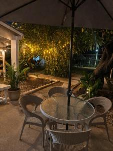 a table with chairs and an umbrella on a patio at Hotel Luna Del Rio in Puerto Salgar