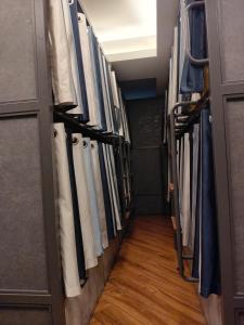 a hallway filled with lots of clothes at Charyana Heights Ac Dormitory in Ahmedabad
