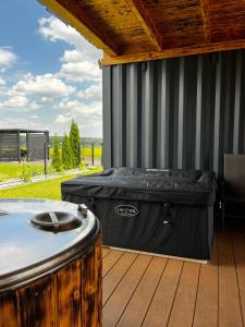 a hot tub sitting on a deck next to a hot tub at Apartament Glamour II Kleszczów in Łękińsko