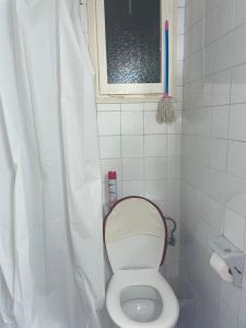 a small bathroom with a toilet and a window at Appartement in Girona +8 photos