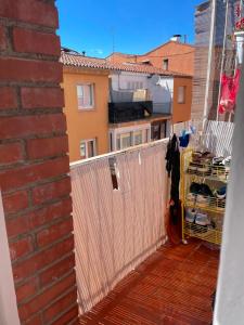 a balcony with a white fence and a building at Appartement in Girona