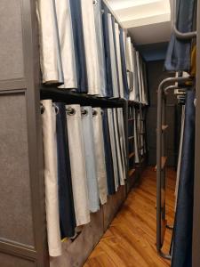 a row of towels are hanging in a closet at Charyana Heights Ac Dormitory in Ahmedabad
