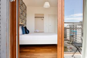 a small bedroom with a bed and a balcony at B&B Best Hostel Milano in Milan