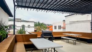 a patio with a table and a grill on a building at KingsLanding in Morelos