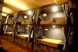 a room with three bunk beds in a room at Charyana Heights Ac Dormitory in Ahmedabad