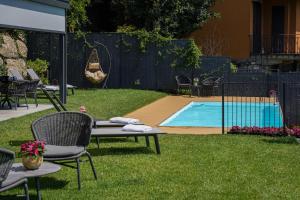 a yard with chairs and a swimming pool at B&B Antenhofer Lovere in Lovere +56 photos