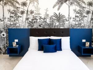 a bedroom with a large bed with blue walls and palm trees at B&B Best Hostel Milano in Milan +51 photos
