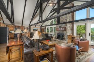 a living room with leather furniture and a fireplace at Majestic Mountain Haus in Beech Mountain
