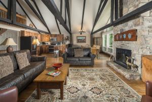 a living room with a couch and a fireplace at Majestic Mountain Haus in Beech Mountain