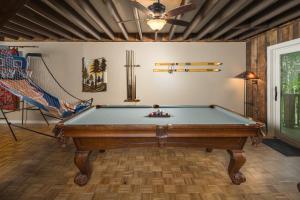 a pool table in a living room with a ceiling at Majestic Mountain Haus in Beech Mountain