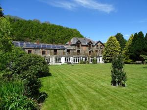 a large house with a large lawn in front of it at Staghunters Inn Hotel in Countisbury