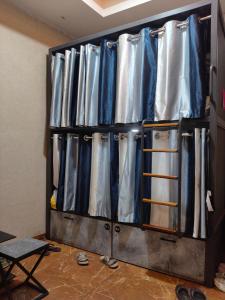 a room with a rack of metal tanks at Charyana Heights Ac Dormitory in Ahmedabad