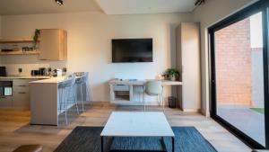 a kitchen and living room with a table at The Circle Luxury Self Catering Studios in Potchefstroom