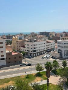 a view of a city with a street and buildings at Hôtel City Center in Nador +18 photos
