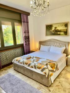 a bedroom with a large bed with a chandelier at Abir's Apartments 2 in Marghera