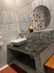 a bathroom with a sink and a mirror at Merwenstein - Farm House, Cottages, Studio-Units in Bonnievale +20 photos