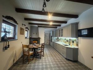 a kitchen with a table and chairs in a room at Чарунки днів in Mukacheve