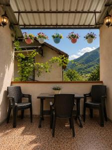 a patio with a table and chairs and a window at Guest house DAVID in Borjomi