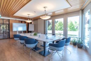a conference room with a large table and chairs at Hotel Seaside in Spiez