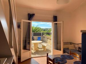 a living room with a door open to a patio at Mas des Petits Loups in Cabrières