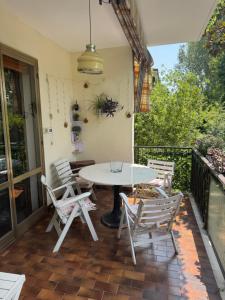 a patio with a table and chairs on a balcony at Abir's Apartments 2 in Marghera