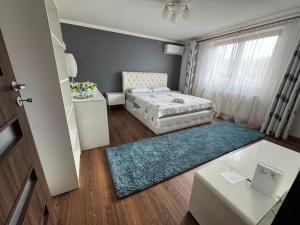 a bedroom with a bed and a blue rug at Casa Aura in Hunedoara