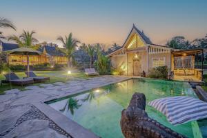 a swimming pool in the backyard of a house at Sacred Padi Ubud Villa in Payangan