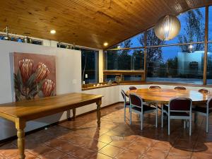 a dining room with a table and chairs at Merwenstein - Farm House, Cottages, Studio-Units in Bonnievale