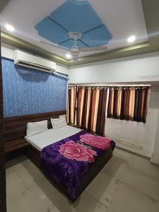 a bedroom with a bed with flowers on it at Hotel Apex in Mahesāna