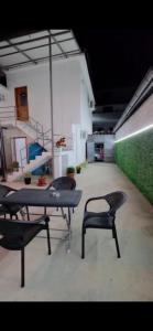 a room with a table and chairs in a building at Aer Rooms Peshkopi in Peshkopi