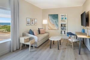 a living room with a couch and a table at Fairfield Inn & Suites by Marriott Melbourne Beach in Melbourne