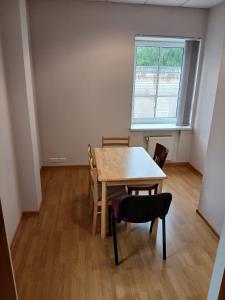 a room with a table and chairs and a window at Venta stay in Ventspils