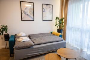 a room with a bed and a table in it at JM Apartment in Poprad