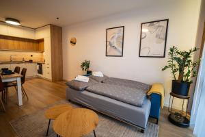 a living room with a couch and a kitchen at JM Apartment in Poprad