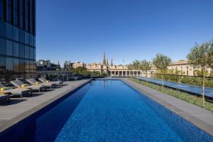 a swimming pool on the roof of a building at Le Meridien Melbourne in Melbourne