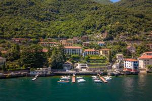 an aerial view of a town with boats in the water at Lakeside Garden Studio in Laglio