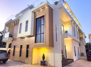 a house with a car parked in front of it at Rosedale luxury apartment in Ashouman