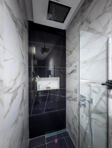 a bathroom with a shower and a glass shower stall at Rosedale luxury apartment in Ashouman +20 photos