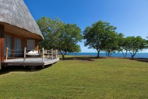 a porch of a house with a view of the ocean at Le Domaine Deva, Series by Marriott in Bourail