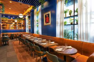 a dining room with wooden tables and chairs at Four Points by Sheraton Manhattan Midtown West in New York
