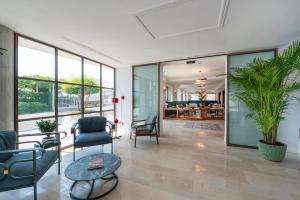 a living room with chairs and a table at Il Tipografo di Amalfi A Family Museum Hotel in Amalfi