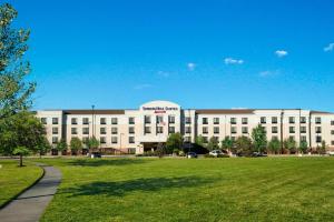 a large white building with a lawn in front of it at SpringHill Suites by Marriott Omaha East, Council Bluffs, IA in Council Bluffs