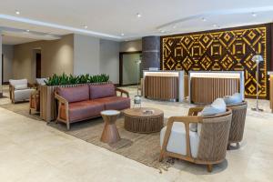 a lobby with couches and chairs and a fireplace at Marriott Executive Apartments Panama City, Finisterre in Panama City
