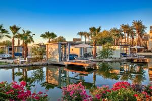 a house on the water with palm trees at JW Marriott Phoenix Desert Ridge Resort & Spa in Phoenix